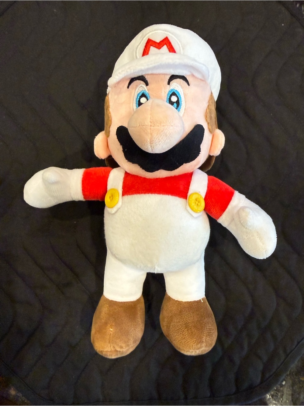 Super Mario “Fire Mario” plush in the white-and-red power-up outfit.